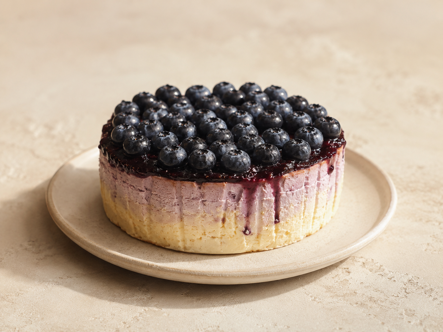A whole Double-Layer Blueberry Basque cooling in its parchment collar